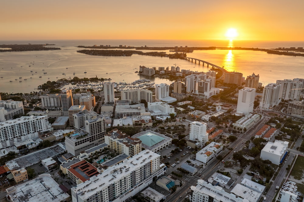 Sarasota, Florida city downtown at sunset with expensive waterfront high-rise buildings. Urban travel destination in the USA